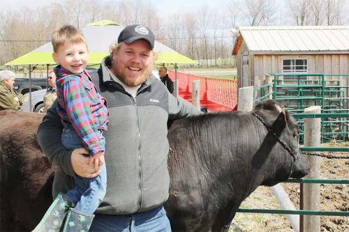 DJ Cooke and son with one of Otter Creek's cows.